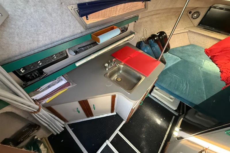 Slide: The Image of Interior of 1988 Cruisers Yachts 2470 Holiday with kitchenette and seating area. - 6