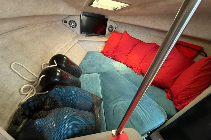 Slide: The Image of Cozy cabin interior of 1988 Cruisers Yachts 2470 Holiday with red cushions and blue seating. - 7