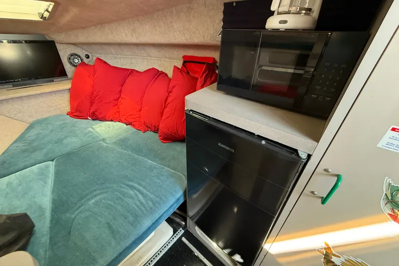 Slide: The Image of Interior of 1988 Cruisers Yachts 2470 Holiday with sofa, microwave, and mini fridge. - 8