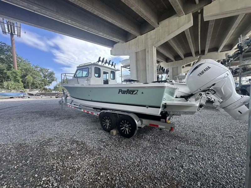 Slide: The Image of 2026 Parker 247 Explorer with Yamaha engines parked under bridge. - 4