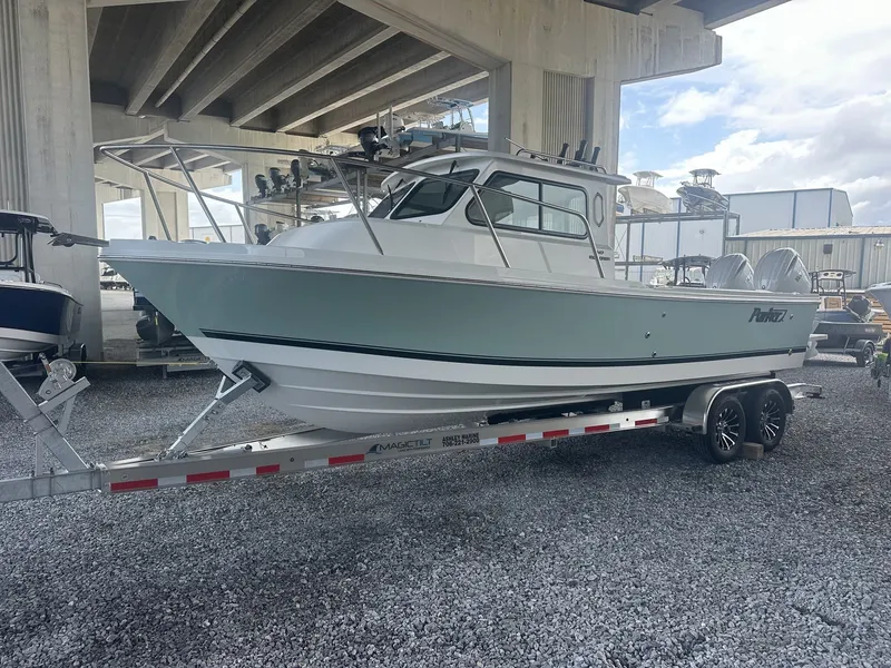 Slide: The Image of Parker 247 Explorer boat 2026 on trailer under bridge. - 3