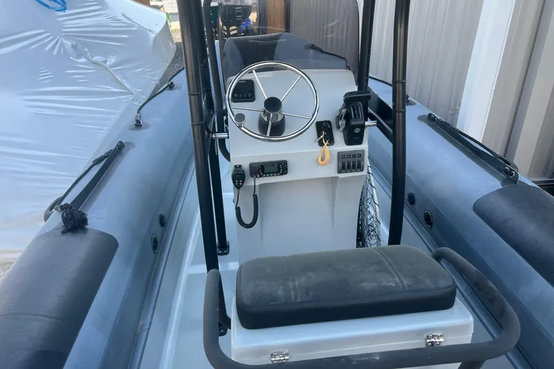 Slide: The Image of 2023 Inmar 600R-PT boat interior with steering console and seating. - 10