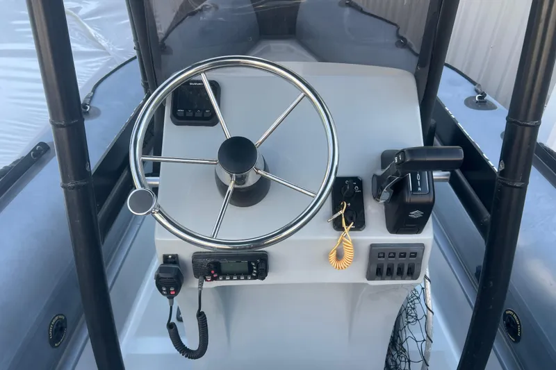Slide: The Image of 2023 Inmar 600R-PT boat console with steering wheel and controls. - 11