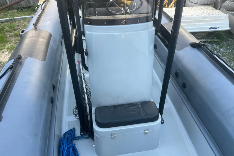 Slide: The Image of 2023 Inmar 600R-PT boat interior with console and seating, featuring blue rope. - 16