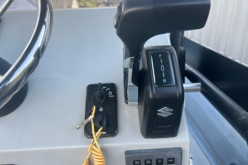 Slide: The Image of 2023 Inmar 600R-PT boat controls with steering wheel and throttle lever. - 17