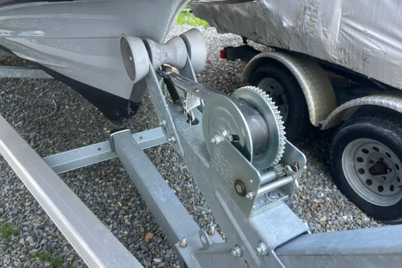 Slide: The Image of Trailer winch system for 2023 Inmar 600R-PT boat, parked on gravel. - 27