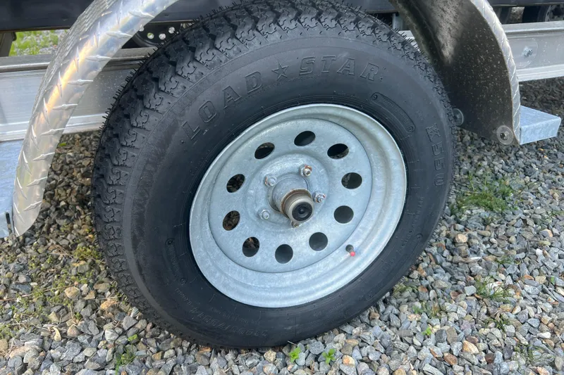 Slide: The Image of Trailer wheel with Load Star tire on gravel, featuring Inmar 600R-PT, 2023 model. - 30