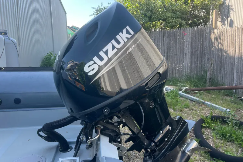 Slide: The Image of Outboard motor on 2023 Inmar 600R-PT boat, featuring Suzuki branding. - 6