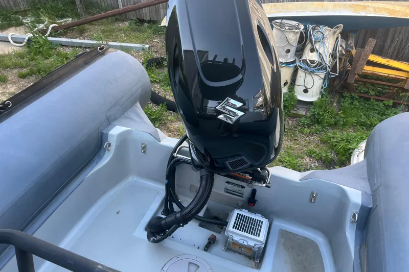 Slide: The Image of 2023 Inmar 600R-PT boat with Suzuki outboard motor, docked outdoors. - 9