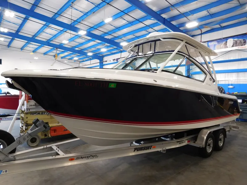 The Image of 2022 Pursuit DC 266 Dual Console boat in a showroom. - 1