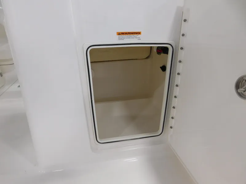 Slide: The Image of 2022 Pursuit DC 266 Dual Console storage hatch. - 18