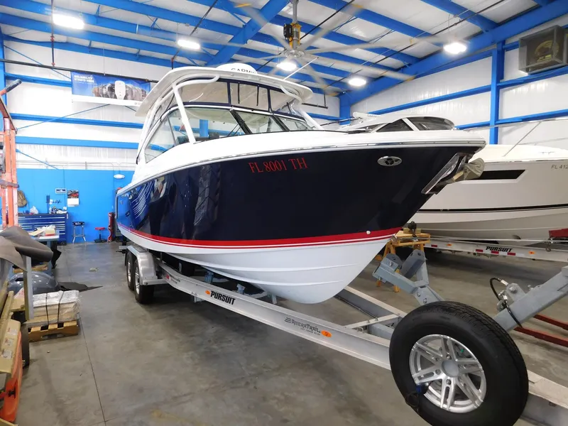 Slide: The Image of 2022 Pursuit DC 266 Dual Console boat in a workshop. - 4