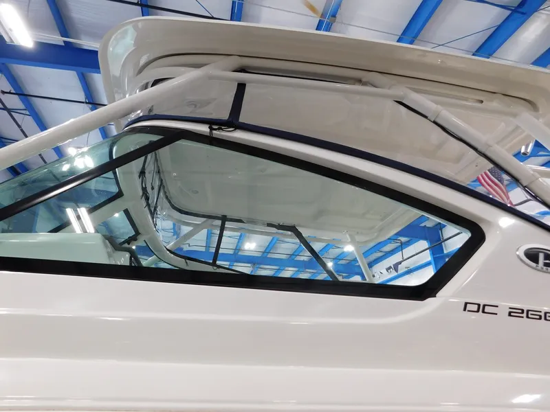 Slide: The Image of 2022 Pursuit DC 266 Dual Console boat in a showroom. - 6