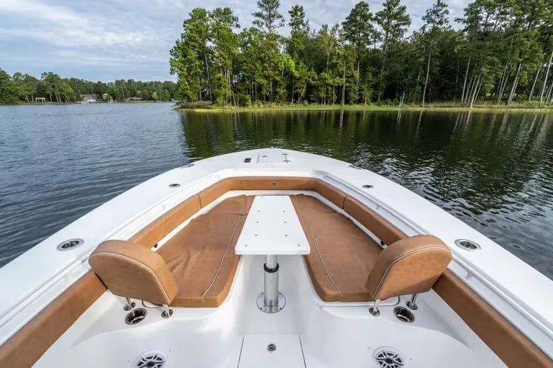 Slide: The Image of Sea Hunt Ultra 285 SE 2026 on calm lake with forest backdrop. - 14
