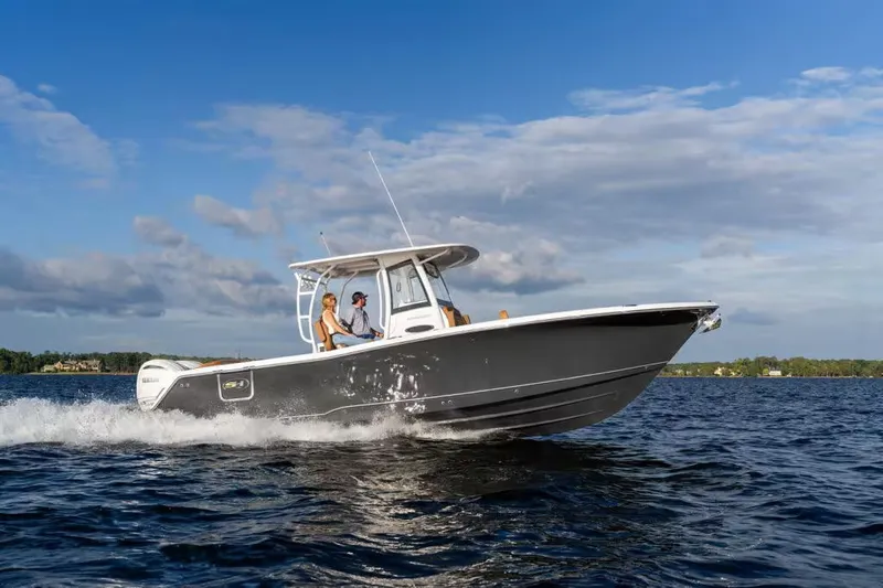 Slide: The Image of 2026 Sea Hunt Ultra 285 SE boat cruising on water. - 2