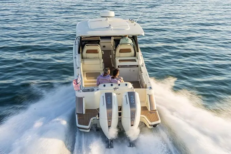 Slide: The Image of Manufacturer Provided Image: 2025 Chris-Craft Calypso 32 cruising on open water, rear view. - 3