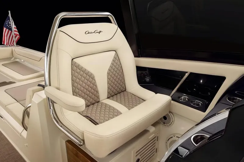 Slide: The Image of Manufacturer Provided Image: Luxurious seating on 2025 Chris-Craft Calypso 32 boat with elegant design and American flag. - 6
