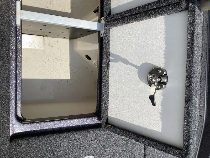 Slide: The Image of Ranger Z520R 2025 boat compartment with open lid and latch. - 24