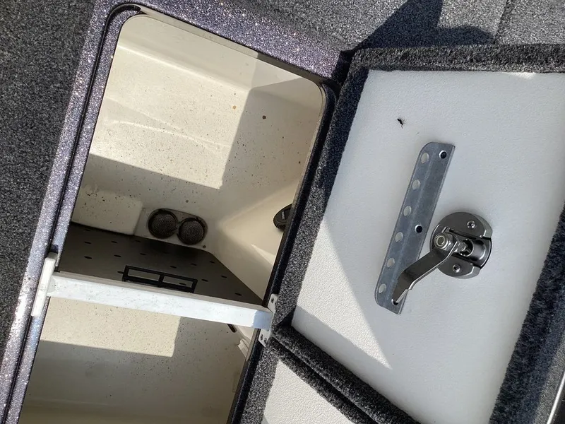 Slide: The Image of Ranger Z520R 2025 storage compartment with open lid and hinge. - 25