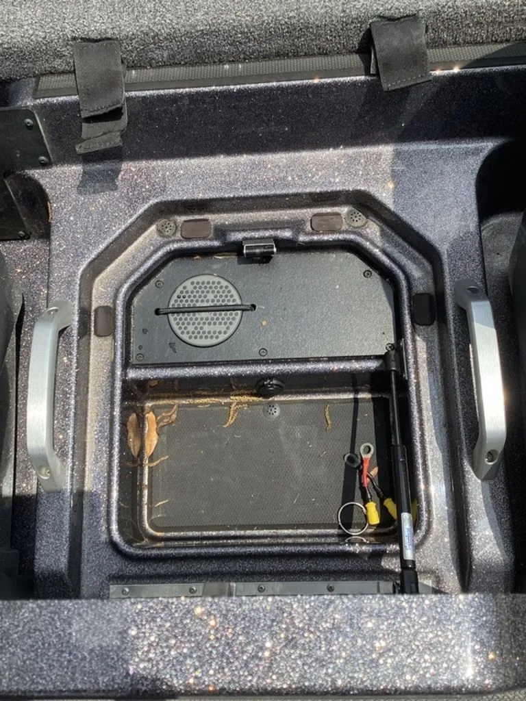 Slide: The Image of Interior of a 2025 Ranger Z520R with storage compartment and accessories. - 36