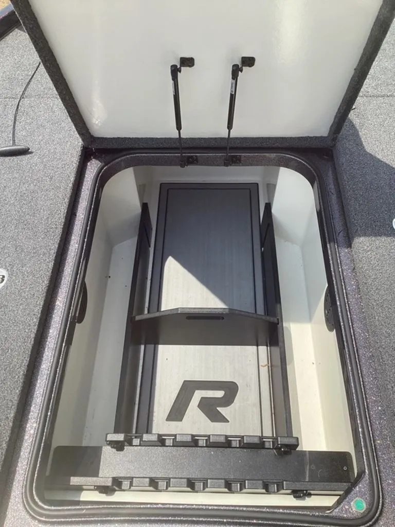 Slide: The Image of Ranger Z520R 2025 boat storage compartment with open lid. - 41