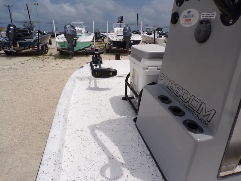 Slide: The Image of 2024 Freedom 14 CHIQUITA boat in a parking lot. - 16