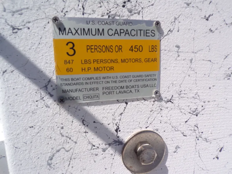 Slide: The Image of US Coast Guard capacity label on Freedom 14 CHIQUITA boat. - 24