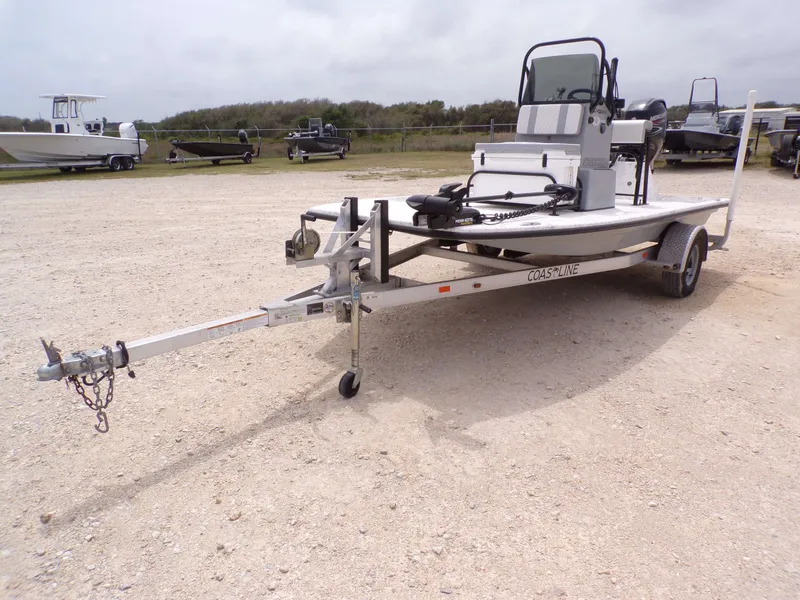 Slide: The Image of 2024 Freedom 14 CHIQUITA boat on trailer in gravel lot. - 3