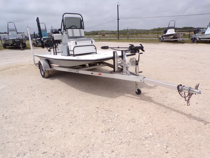 Slide: The Image of 2024 Freedom 14 CHIQUITA boat on trailer in gravel lot. - 7