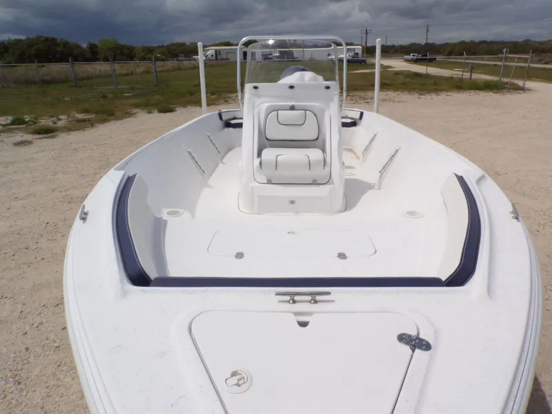 Slide: The Image of 2023 K2 Powerboats 22CRS on gravel lot under cloudy sky. - 11