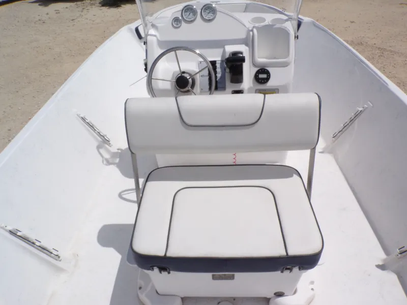 Slide: The Image of Interior view of 2023 K2 Powerboats 22CRS with white seating and helm. - 19