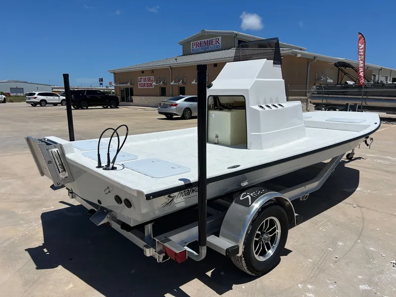 Slide: The Image of 2026 Shoalwater 19' Catamaran on trailer outside boat dealership. - 9