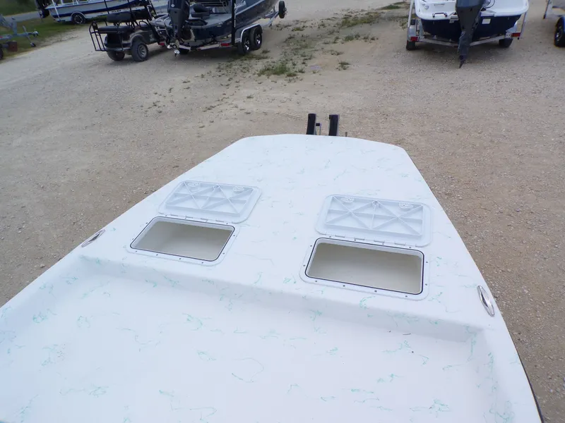 Slide: The Image of 2026 Shoalwater 19' Catamaran with storage hatches on gravel lot. - 21