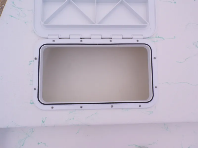 Slide: The Image of Open storage compartment on a 2026 Shoalwater 19' Catamaran. - 23