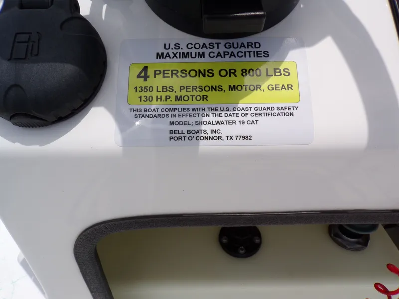 Slide: The Image of US Coast Guard capacity label on Shoalwater 19' Catamaran, 2026 model. - 26