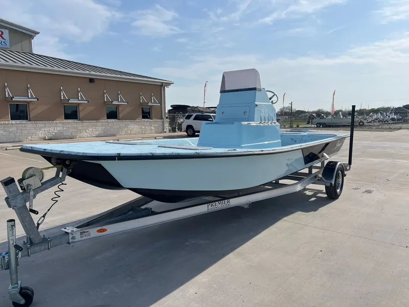 Slide: The Image of 2026 Shoalwater 20' Catamaran on trailer in front of building. - 3