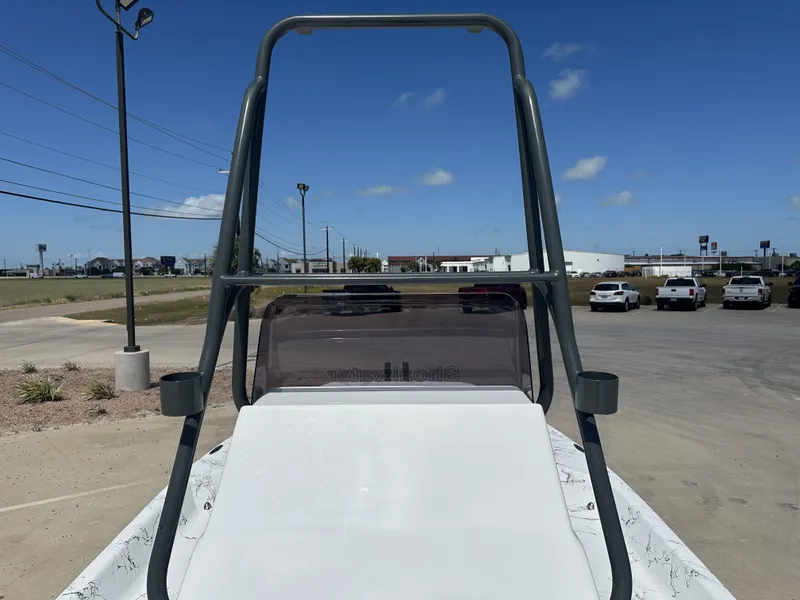 Slide: The Image of 2026 Shoalwater 21' Catamaran on a parking lot under sunny skies. - 10