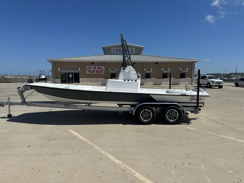 Slide: The Image of 2026 Shoalwater 21' Catamaran on trailer outside boat dealership. - 13