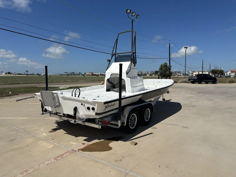 Slide: The Image of 2026 Shoalwater 21' Catamaran on trailer under sunny skies. - 16