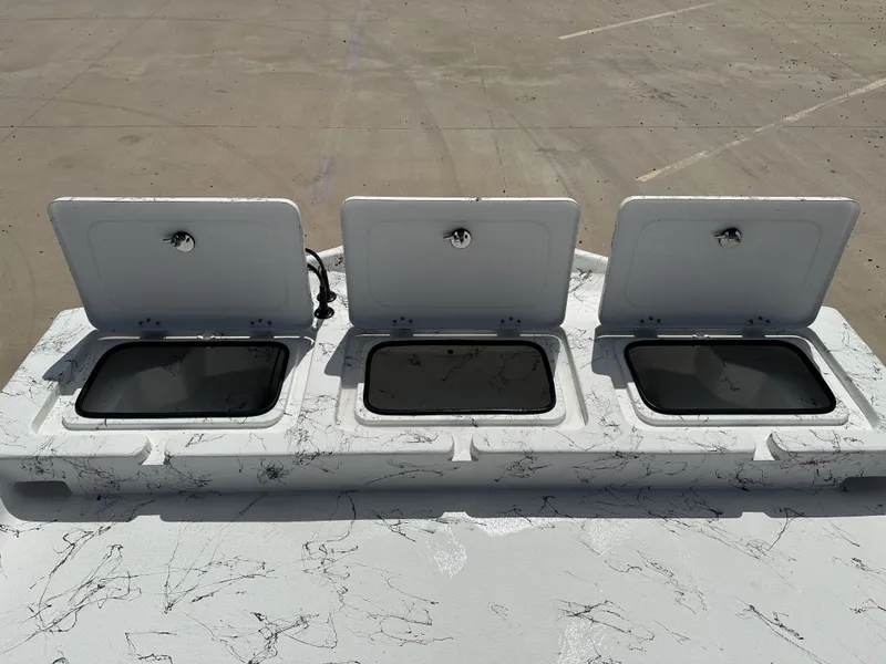Slide: The Image of Three open storage compartments on a 2026 Shoalwater 21' Catamaran. - 21