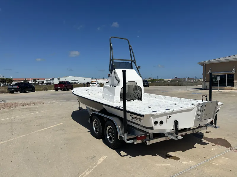 Slide: The Image of 2026 Shoalwater 21' Catamaran parked outdoors on a trailer. - 6