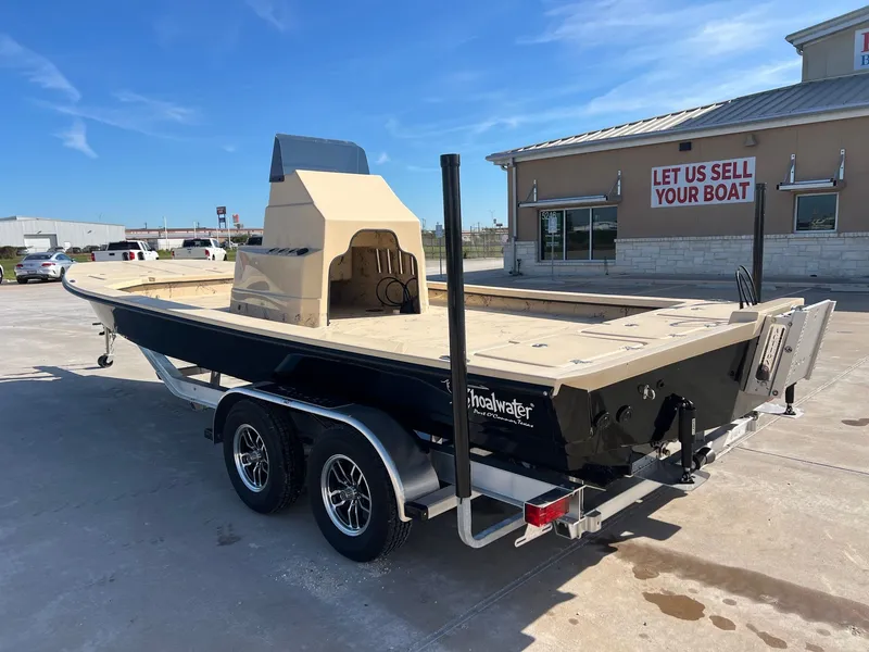 Slide: The Image of 2026 Shoalwater 23' Catamaran on trailer outside sales building. - 11
