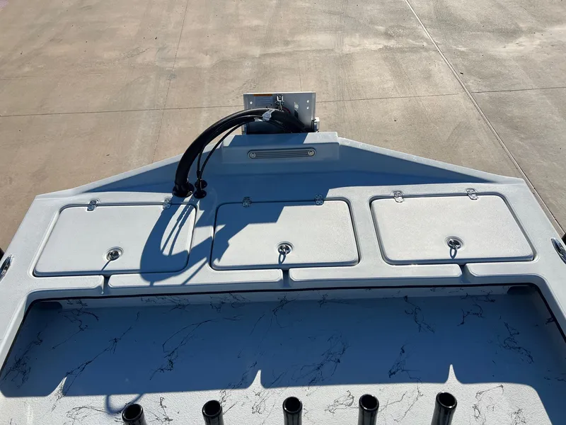 Slide: The Image of Deck of a 2026 Shoalwater 23' Catamaran with storage compartments. - 16