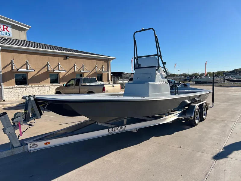 Slide: The Image of 2026 Shoalwater 23' Catamaran on trailer outside a building. - 3