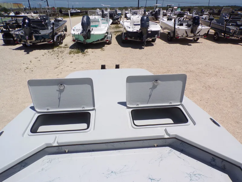 Slide: The Image of Front view of a 2025 Shoalwater 23' Catamaran with open storage compartments. - 18