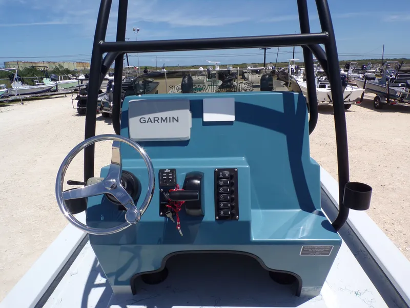 Slide: The Image of Shoalwater 23' Catamaran 2025 helm with Garmin device. - 23
