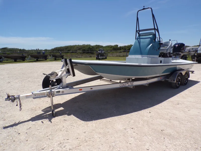 Slide: The Image of 2025 Shoalwater 23' Catamaran on trailer outdoors. - 3