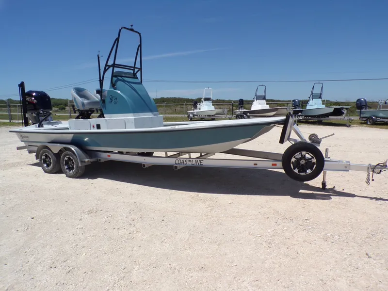 Slide: The Image of 2025 Shoalwater 23' Catamaran on trailer outdoors. - 7