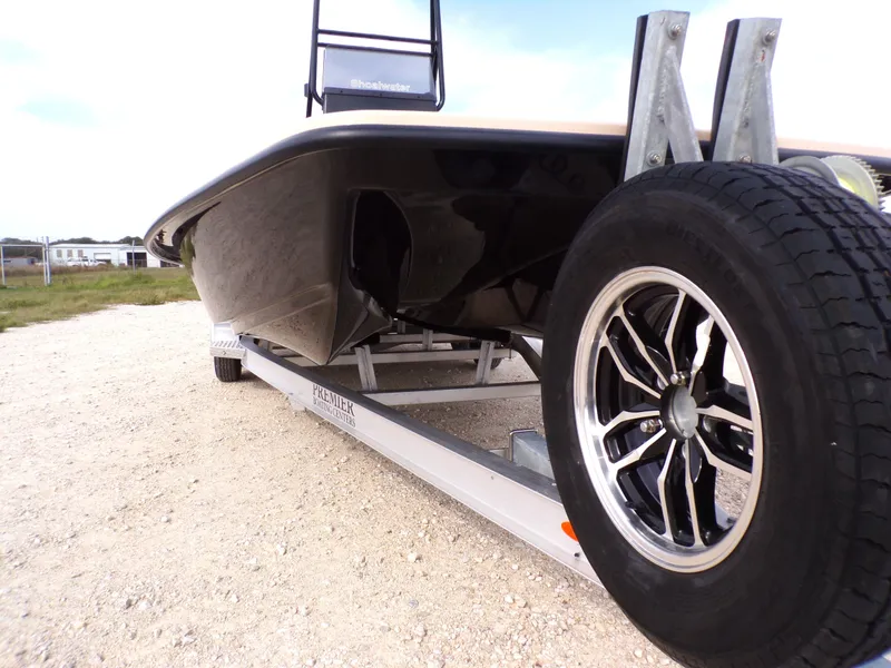 Slide: The Image of Shoalwater 23' Catamaran 2026 on trailer, close-up of wheel. - 15