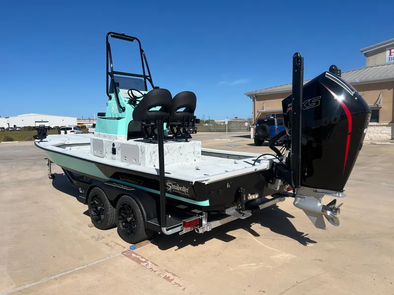 Slide: The Image of 2026 Shoalwater 23' Catamaran on trailer, outboard motor, sunny day. - 13